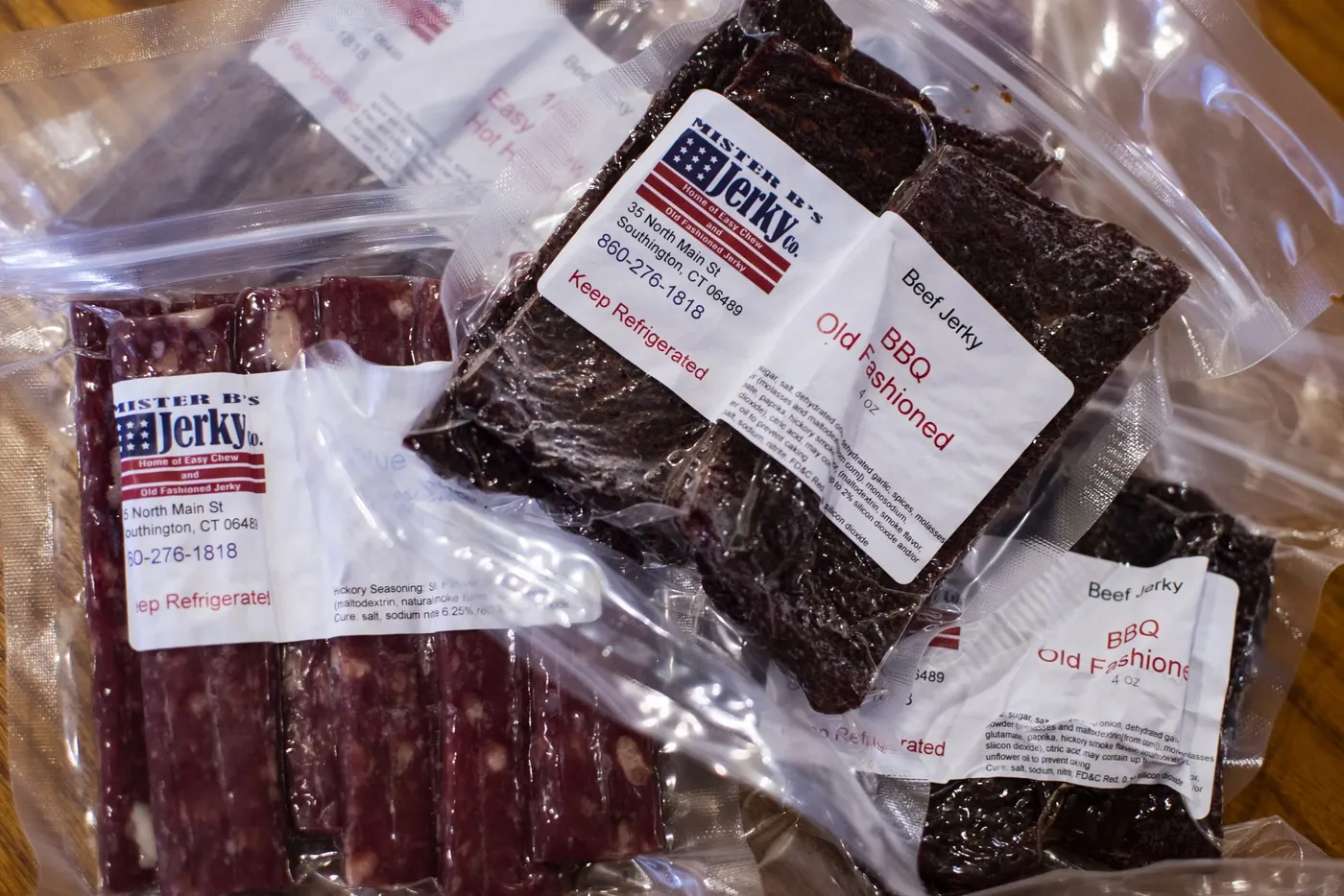 Vacuum-sealed bags of Mister B’s jerky and sticks with the red, white, and blue label