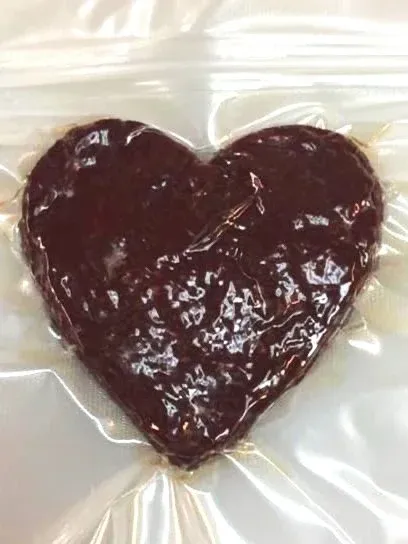 A heart-shaped piece of Easy Chew jerky, vacuum sealed